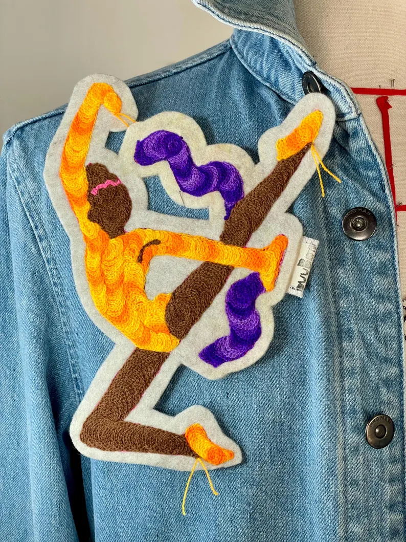 il 794xn.6343464740 piy8.jpg Ajoutez une touche sportive et artistique à votre garde-robe avec ce patch brodé gymnaste ruban, célébrant les Jeux Olympiques Paris 2024. Marque buuBoo.