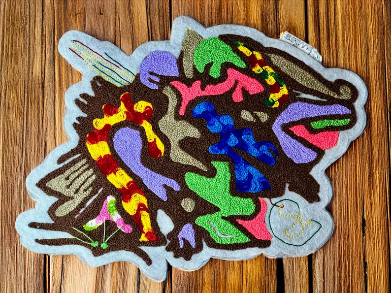 il 794xn.6380391970 1x13.jpg Ce patch coloré est magnifique. La broderie au point de chaîne ajoute une touche artisanale unique et une texture intéressante. Ce patch est un véritable chef-d’œuvre avec ses couleurs vives et sa broderie au point de chaîne.